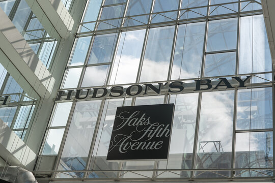 signs for Hudson's Bay and Saks Fifth Avenue located inside the CF Toronto Eaton Centre (south end at Queen Street West) - sky background