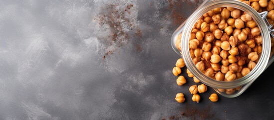 Chickpeas, a member of the legume family and considered a superfood, are spilling out of a glass jar onto a table, ready to be used as an ingredient in various cuisines