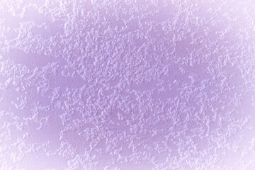 Light pink berry color paint on rough plaster wall solid stucco surface texture background white vignette design