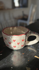 Ceramic cup with hearts on a black background