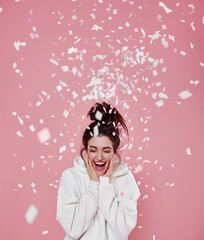Celebrating Success: Woman with Mobile Phone Surrounded by Gold Confetti