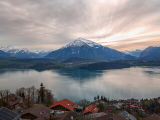 Aeiral image of Niesen mountain, also called as Swiss Pyramid with reflection on the Thun lake