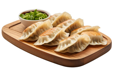Wooden tray holding dumplings and bowl of dipping sauce