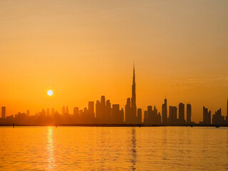 Fototapeta premium amazing sunset view of Dubai Downtown cityline from Dubai Creek harbour