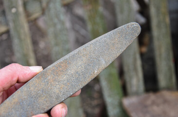 sharpening stone in hand close-up and blurred background.