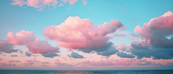 A stunning sky with pink and blue clouds floating over the sea