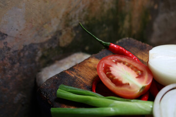 Photos of cooking spices, tomatoes, spring onions, onions and red chilies