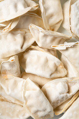 verhead view of frozen uncooked stuffed gyoza food background