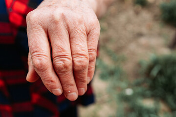 Elderly woman showing her hand. Older people