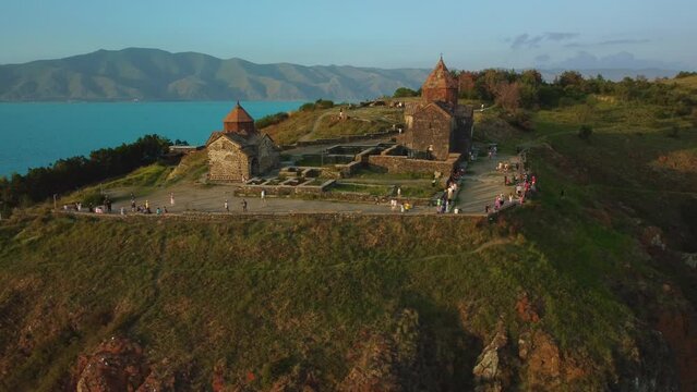 Drone shot of Sevanavank church with the entrance to the peninsula and Lake Sevan in the background.