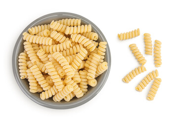 Italian spiral shaped pasta, Fusilli bucati macaroni in ceramic bowl, isolated on white background. Top view. Flat lay.