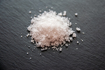 Salt crystals for cooking the food on black background.