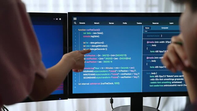 Slow motion back end software developer engineer for computer programming working together on debugging writing computing code, solving complex algorithms display on monitor in office. Burgeoning