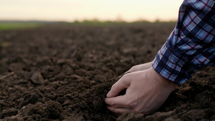 Agricultural industry. Farmer hands hold fertile soil, natural fertilizer, compost. Farmer checks composition of soil before sowing. Man, woman holding land in hands in close-up. Concept agriculture - obrazy, fototapety, plakaty