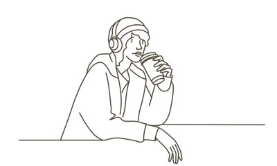 A woman is sitting at a table with a cup of coffee in front of him