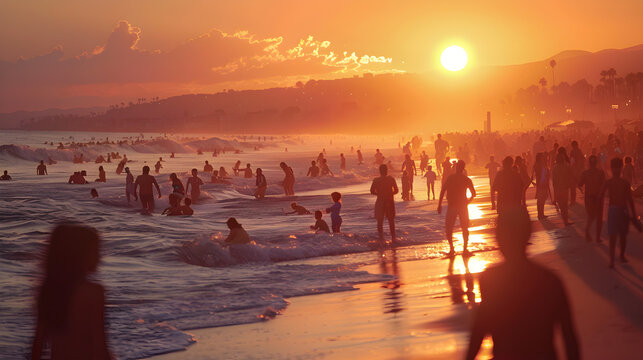 Warm, glowing sunset over a bustling beach filled with people enjoying the summer waves