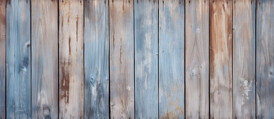 A detailed shot showcasing the intricate pattern of a wooden fence stained in blue and brown colors, displaying the artistry of wood craftsmanship
