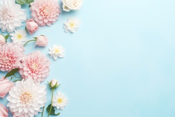 Fototapeta na wymiar Spring or summer floral background with pink roses and chrysanthemums on turquoise pastel color paper. Flat lay, top view, pattern frame made of flowers. Romantic composition for various uses