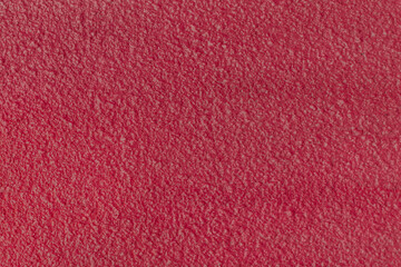 Rough wall plaster concrete crimson color solid surface stucco cement structure background texture abstract