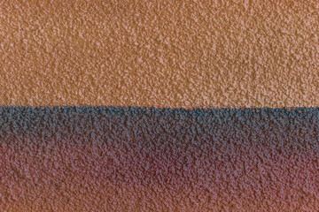 Brown orange plaster wall two colors abstract pattern design stucco background texture empty blank