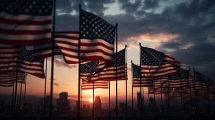 Silhouetted against the fading light, American flags pay tribute to those who served their country. - obrazy, fototapety, plakaty