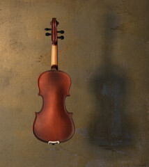 old violin on concrete background