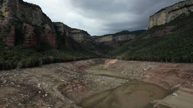 Aerial view of Sau reservoir blue green river Ter shoreline looking down mountain valley. High quality 4k footage