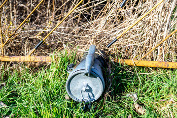 Garden Drain Pipe with Cap near a Rusty Fence