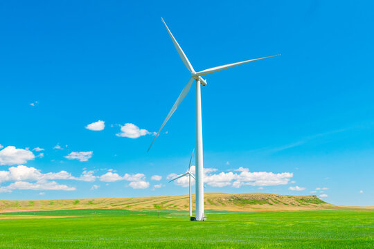 Wind turbine in a summer farm field in southern alberta Canada