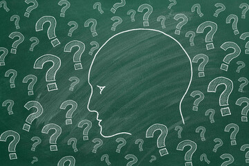 Human head with question marks. Illustration on greenboard.