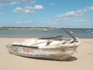 BARCA CON MAR DE FONDO SOBRE LA ARENA.