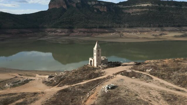 Swamp church Sau swamp dike in Catalonia, Spain, intense drought in 2024 pantano de Sau. High quality 4k footage