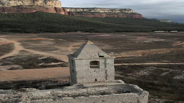 Vertical drone shot of church Sau swamp dike in Catalonia, Spain, drought in 2024 pantano de Sau. High quality 4k footage