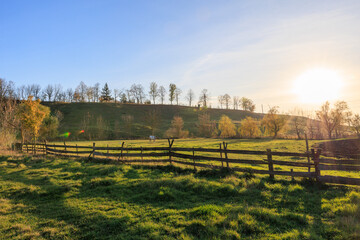 A large, open field with a fence in the middle