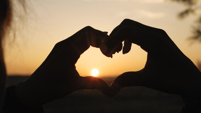 girl heart sign, sunset love symbol, hand silhouette heart, romantic gesture sunset, love hand silhouette, heart shape hands, fingers forming heart, romantic sign sunset, symbol of love sky, romantic