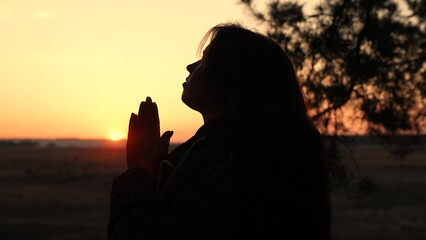girl woman praying at sunset, hand sunset faith pain, asking heaven for help, spiritual sunset...
