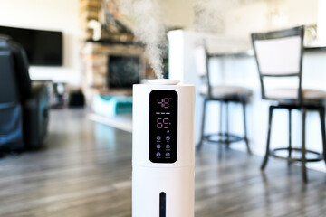 A humidifier at work inside a modern home, with digital readout display showing temperature and humidity levels. - obrazy, fototapety, plakaty