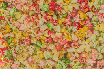 Multicolored sweet popcorn, crunchy corn background texture food