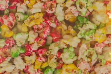 Multicolored sweet popcorn, crunchy corn background texture food color sweet tasty