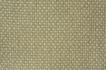Beige matting material made from vintage natural wool close-up