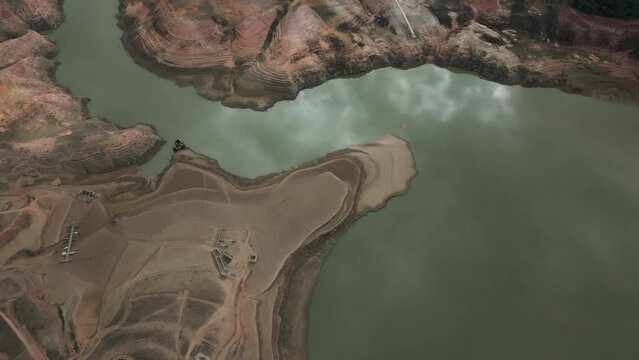 Aerial view of Sau reservoir blue green river Ter shoreline looking down mountain valley. High quality 4k footage