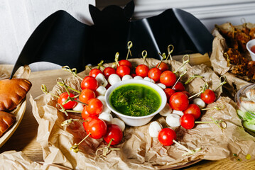 Caprese Skewers with Cherry Tomatoes and Mozzarella. Caprese skewers with ripe cherry tomatoes,...