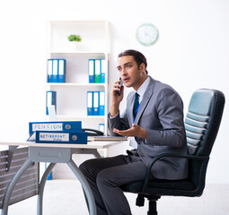 Young male accountant working in the office