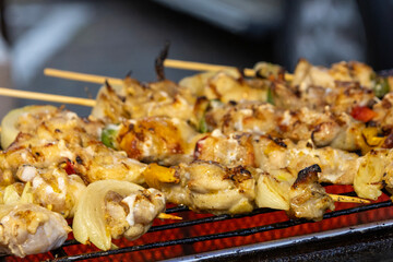 Grilled chicken kebab on a bamboo skewer.
