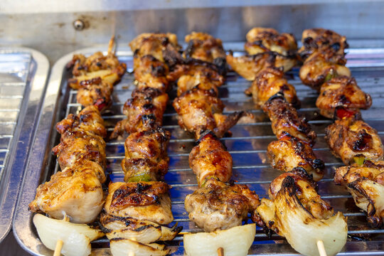 Grilled chicken kebab on a bamboo skewer.
