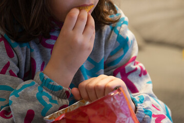 A girl eating potato chips