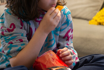 A girl eating potato chips