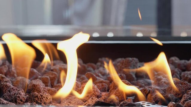Backyard fire pit burning during summer evening. Close up view of flames of firepit on backyard. Slow motion video.