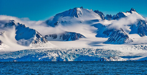 Deep Blue Glacier and Snowcapped Mountains, Albert I Land, Arctic, Spitsbergen, Svalbard, Norway,...