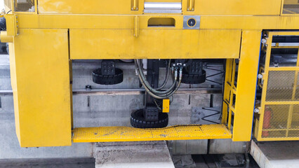 close up of Maintenace car guiding wheel, Yellow monorails maintaining car, stabilizing wheel